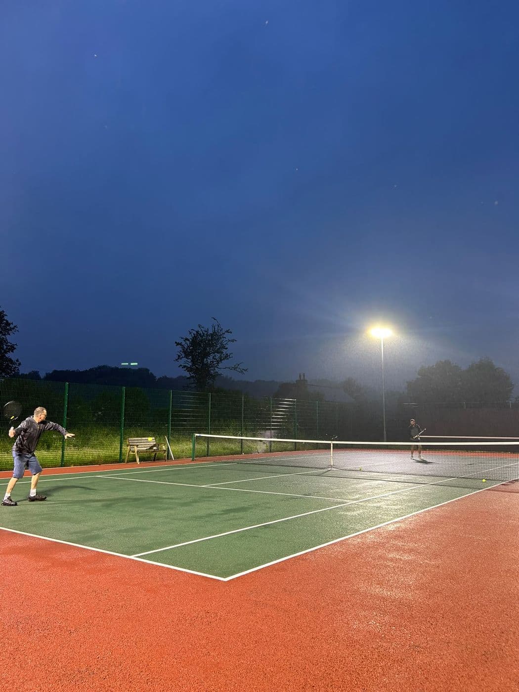 LED floodlighting installed by FRM at the Bamford tennis courts, lit against an evening sky.
