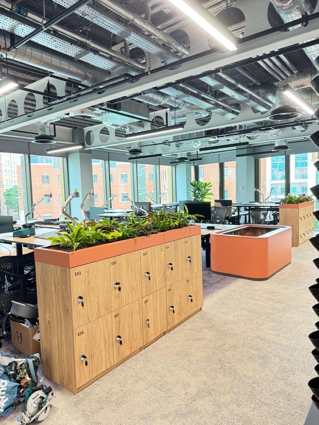 A modern commercial office fit-out by FRM with exposed services, containment and feature lighting.