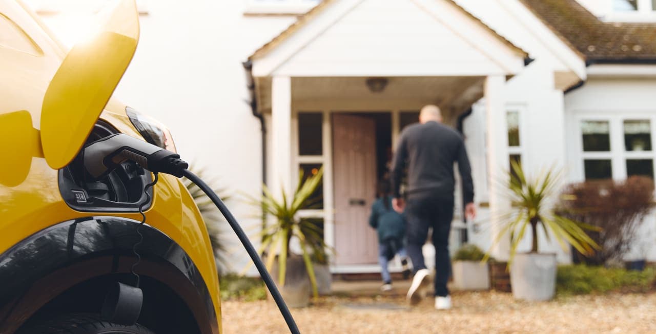 An electric vehicle charging from a home wall-mounted charge point