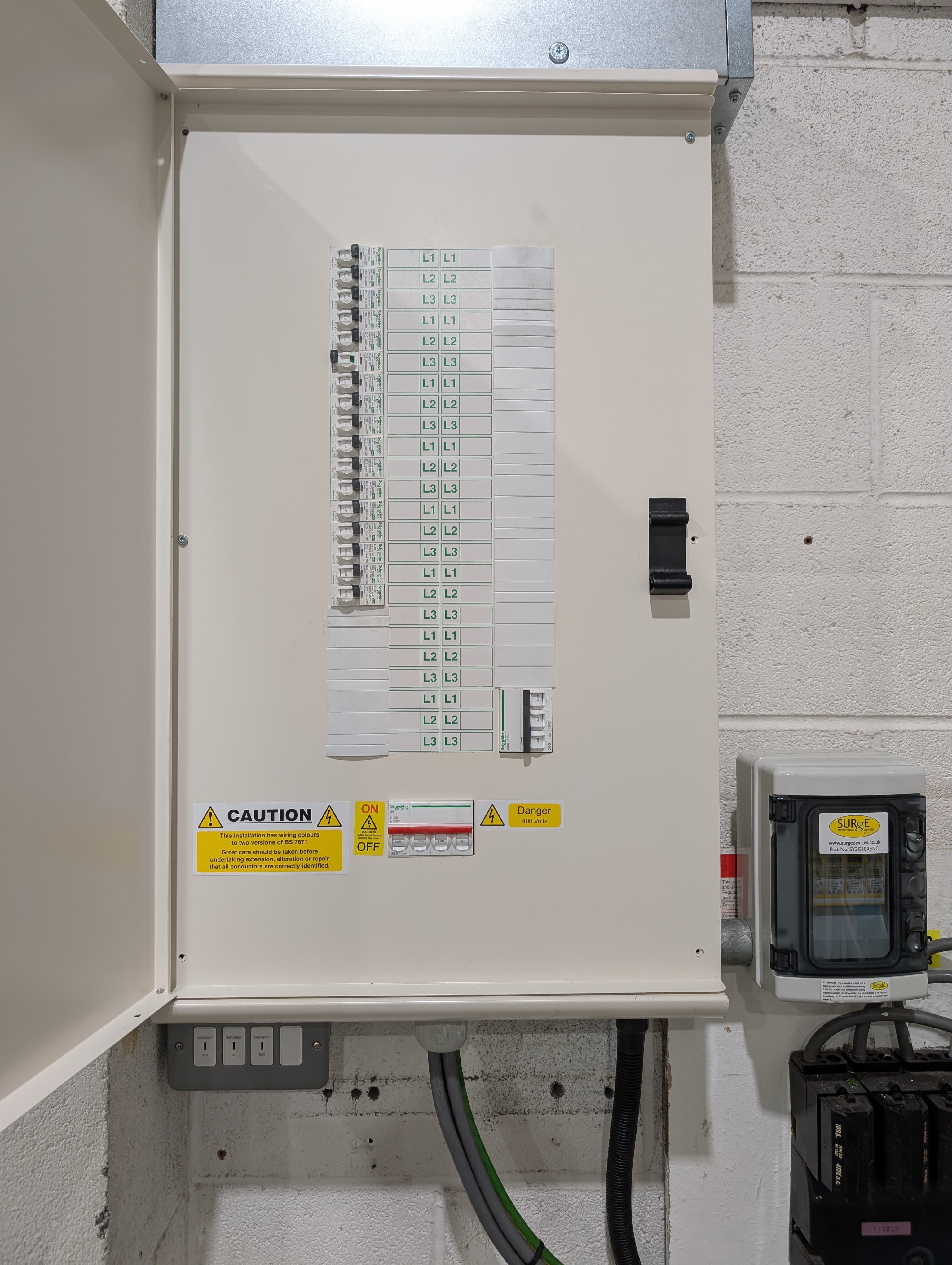 A modern consumer unit (fuseboard) being inspected and tested
